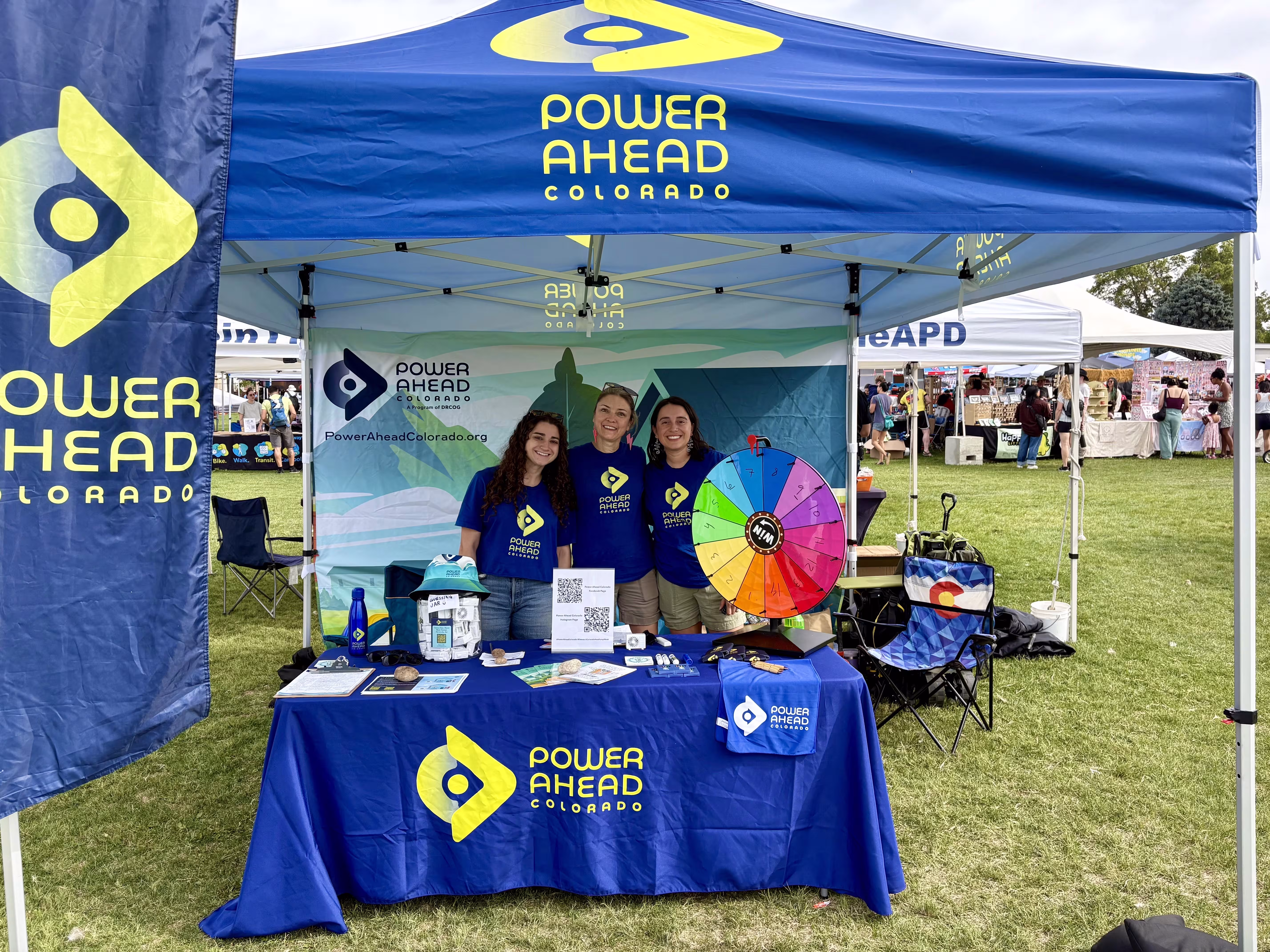 The Power Ahead Colorado team with a tent and table at an event