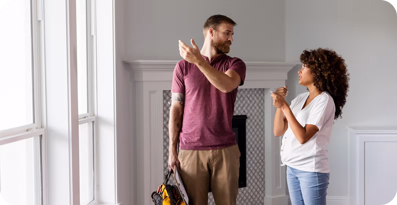 A man and a woman chatting while looking around a home